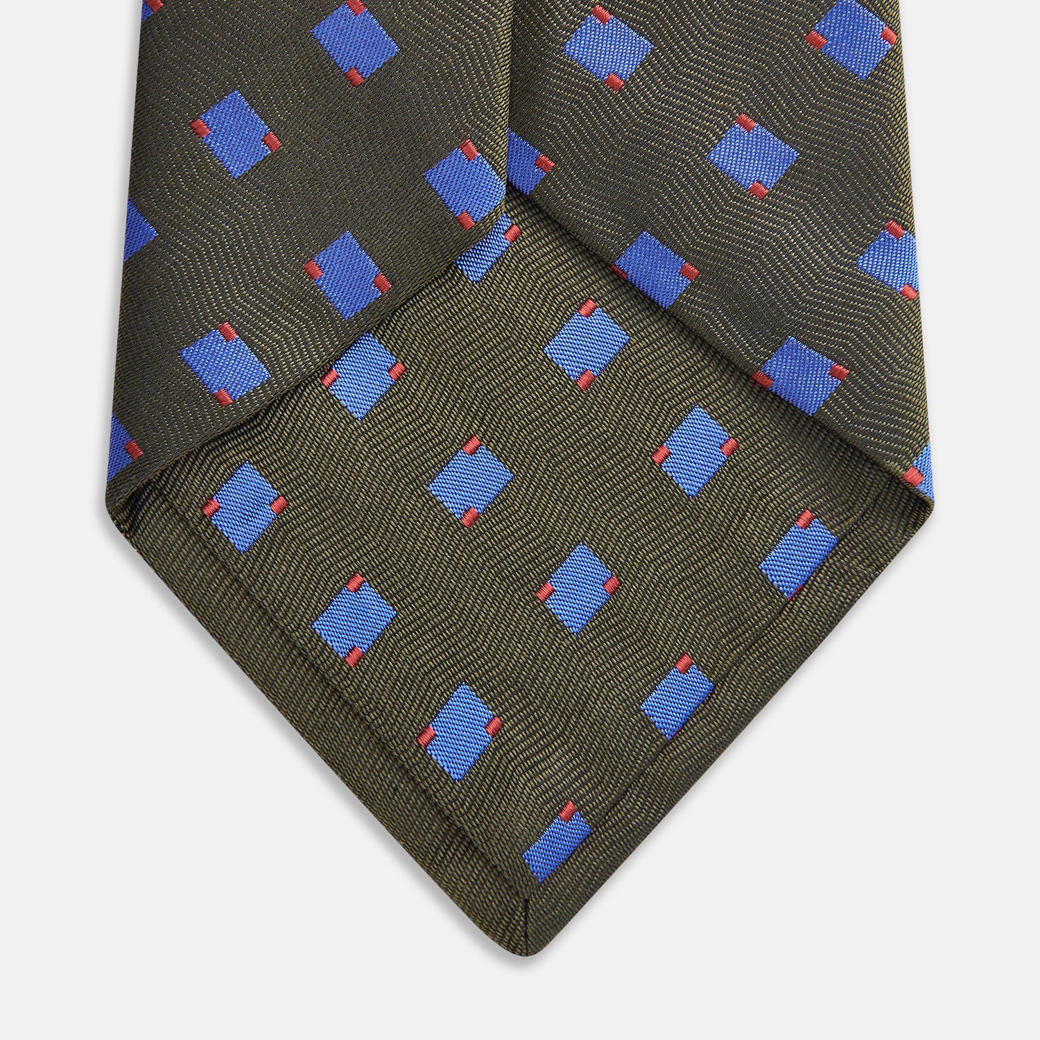 View 3 of product The Turnbull & Asser Dark Green and Blue Tile Silk Tie showcases a classic tile pattern with blue and red squares on herringbone fabric.