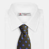 View 4 of product The Turnbull & Asser Dark Green and Blue Tile Silk Tie showcases a classic tile pattern with blue and red squares on herringbone fabric.