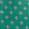 View 3 of product The Turnbull & Asser Kelly Green and Grey Tile Silk Tie features a subtle chevron texture and classic grey tile pattern, displayed rolled on a white background.