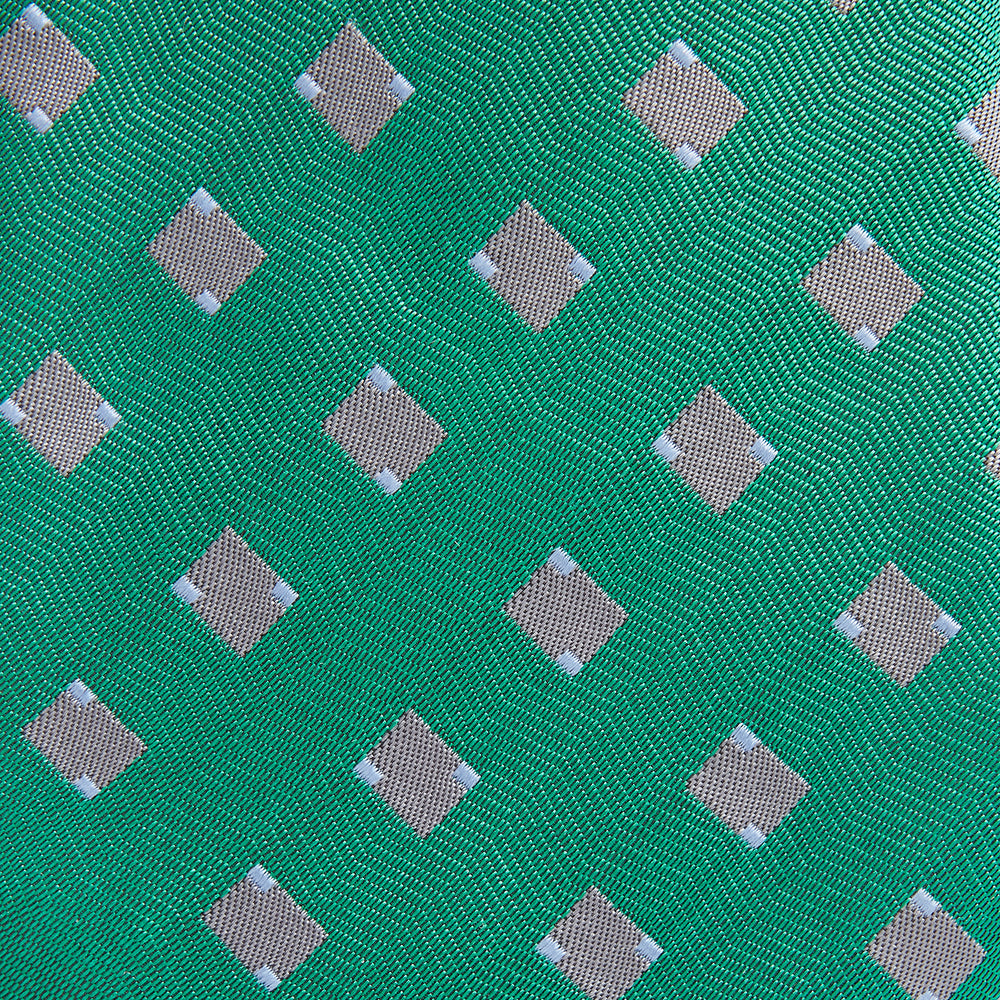 The Turnbull & Asser Kelly Green and Grey Tile Silk Tie features a subtle chevron texture and classic grey tile pattern, displayed rolled on a white background.