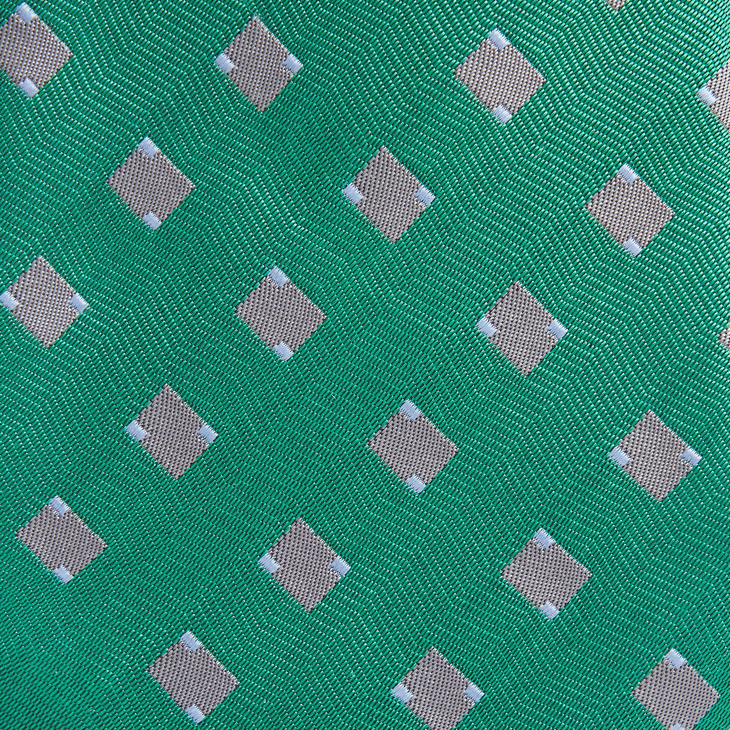 View 3 of product The Turnbull & Asser Kelly Green and Grey Tile Silk Tie features a subtle chevron texture and classic grey tile pattern, displayed rolled on a white background.