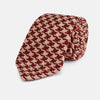 View 1 of product The Red and Peach Houndstooth Wool Blend Tie by Turnbull & Asser features a classic houndstooth pattern in red and peach, expertly crafted for timeless style.