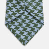 View 3 of product The Turnbull & Asser Green and Blue Houndstooth Wool Blend Tie is rolled up, showcasing its classic pattern against a simple white background.