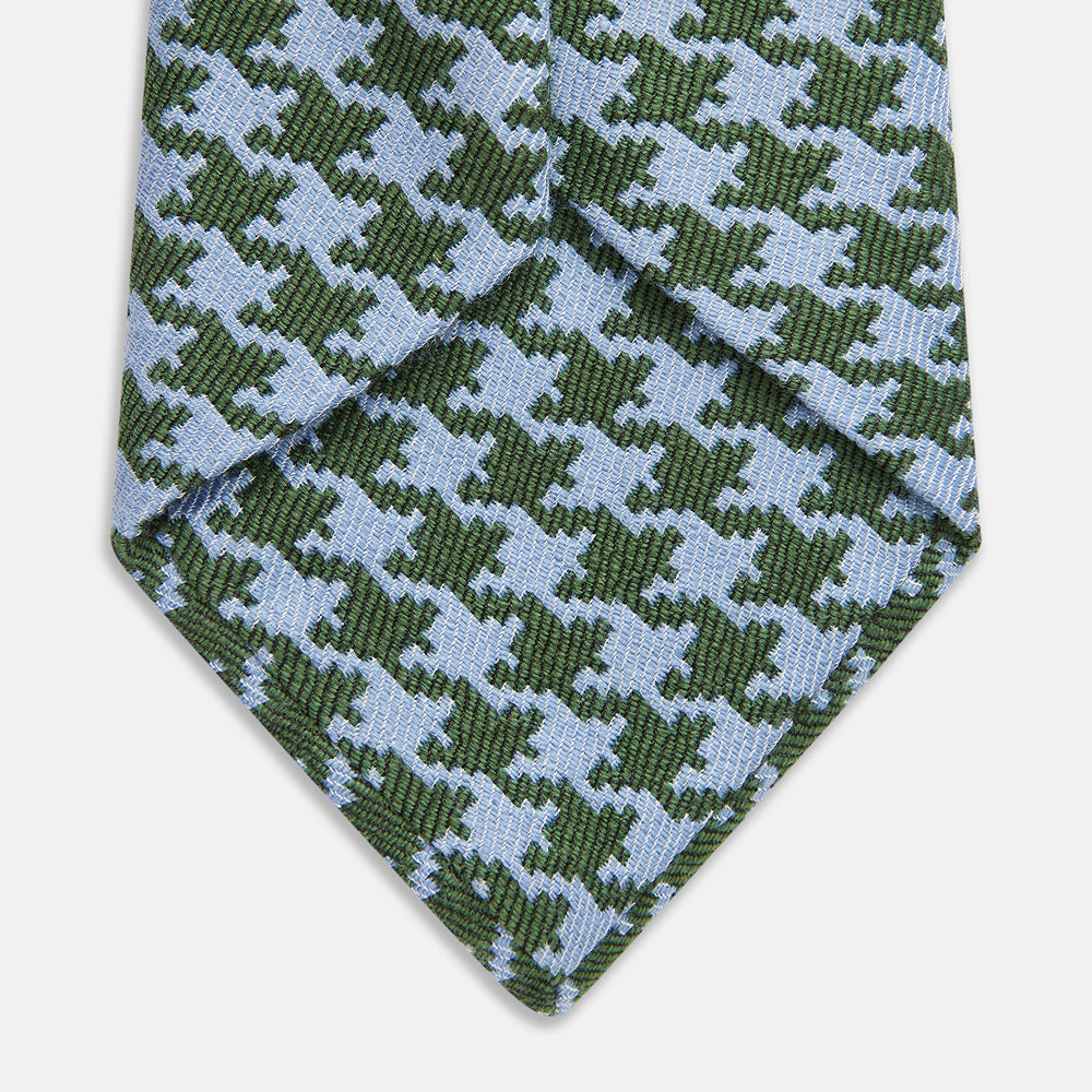 The Turnbull & Asser Green and Blue Houndstooth Wool Blend Tie is rolled up, showcasing its classic pattern against a simple white background.