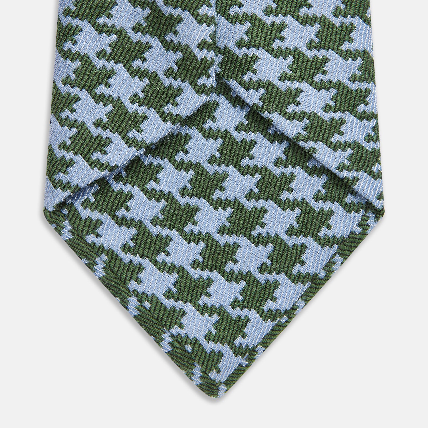 View 3 of product The Turnbull & Asser Green and Blue Houndstooth Wool Blend Tie is rolled up, showcasing its classic pattern against a simple white background.