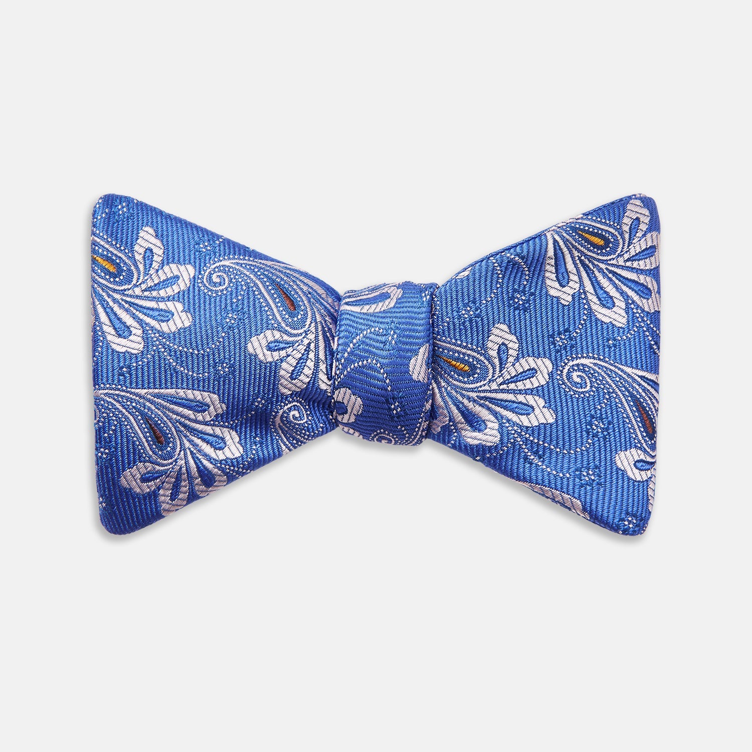 View 1 of product The Turnbull & Asser French Blue Paisley Silk Bow Tie features a white and silver floral paisley pattern, is self-tying, and is shown against a plain white background.