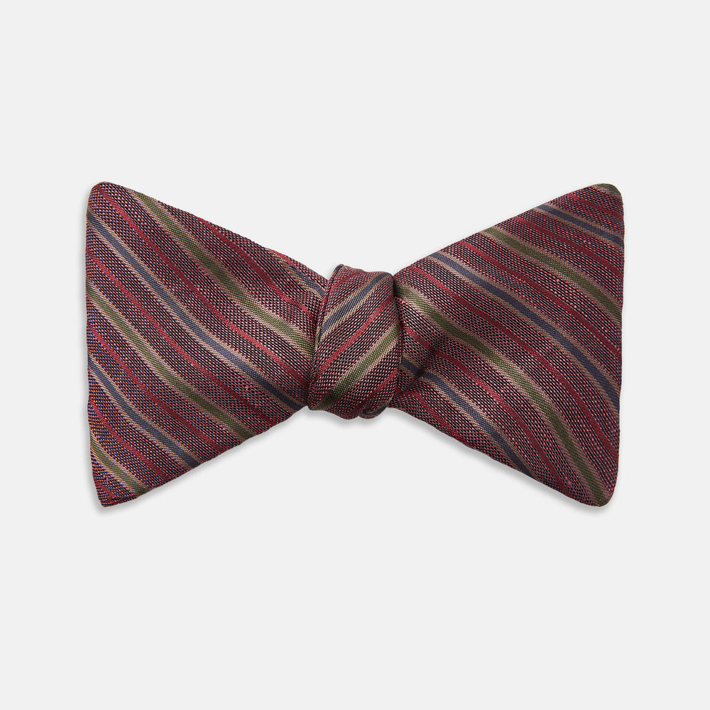 The Turnbull & Asser Claret and Green Multi Stripe Silk and Linen Bow Tie features diagonal stripes in red, beige, and green, shown on a plain white background.