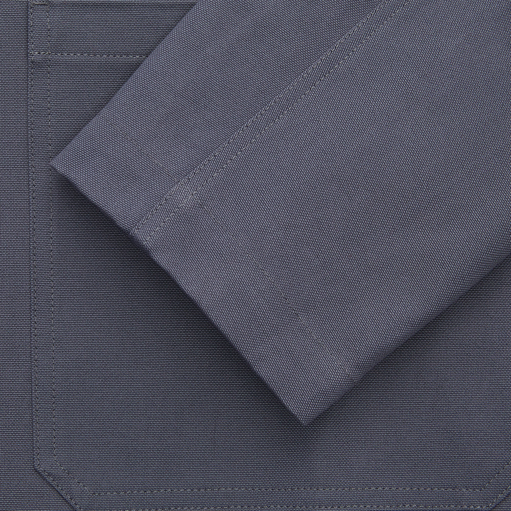 The Turnbull & Asser Charcoal Grey Organic Cotton Blend Remy Chore Jacket features a collar, button-up front, and four front pockets—two chest, two waist—making it a versatile must-have for any men's wardrobe.