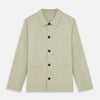 View 1 of product The Turnbull & Asser Tan Organic Cotton Blend Remy Chore Jacket features long sleeves, a collar, button-down front, and three pockets—an essential for any men’s wardrobe. The jacket is shown laid flat on a white background.