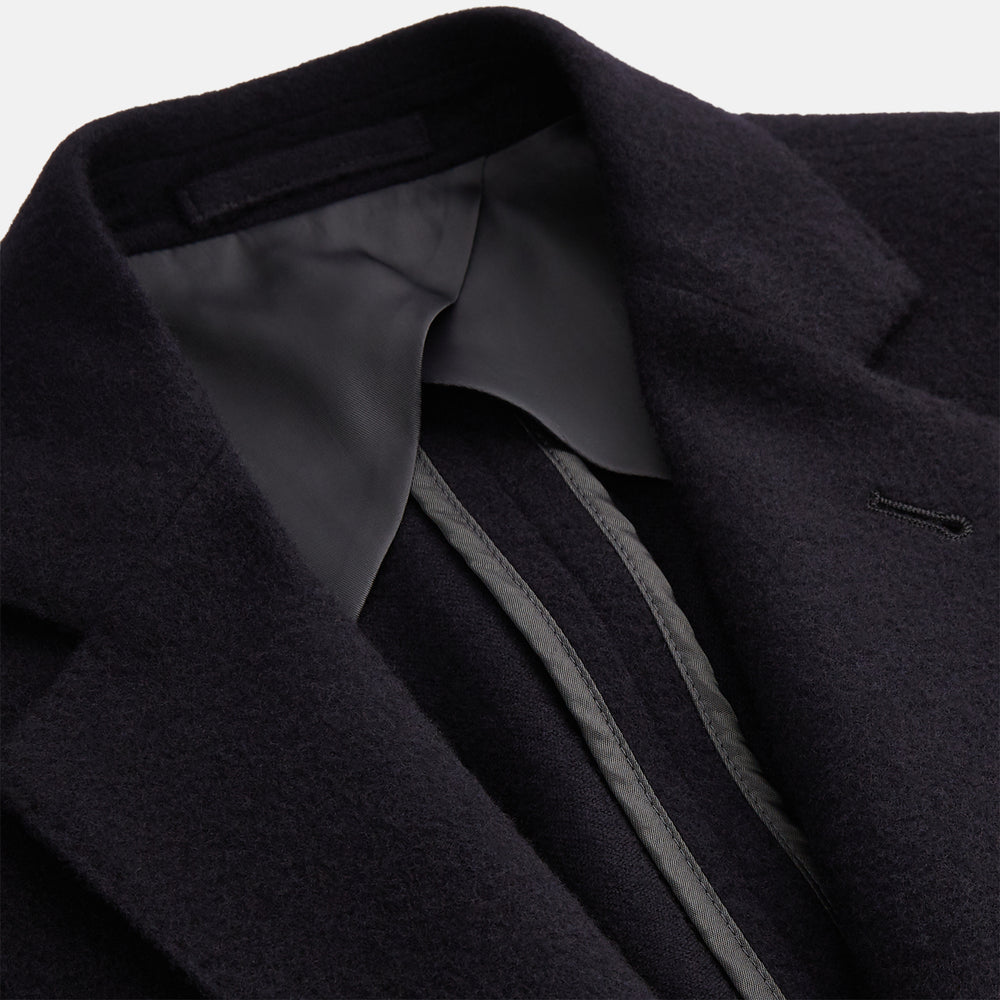 The Turnbull & Asser Navy Cashmere Bern Blazer features a notched lapel, two-button front, three front pockets, and cuff button details. Shown laid flat on a white background.