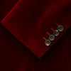 View 3 of product The Turnbull & Asser Wine Velvet Barrington Blazer, tailored in Italy, features a deep red hue, notched lapel, two front buttons, three pockets, and cuff button details. Shown against a plain white background.
