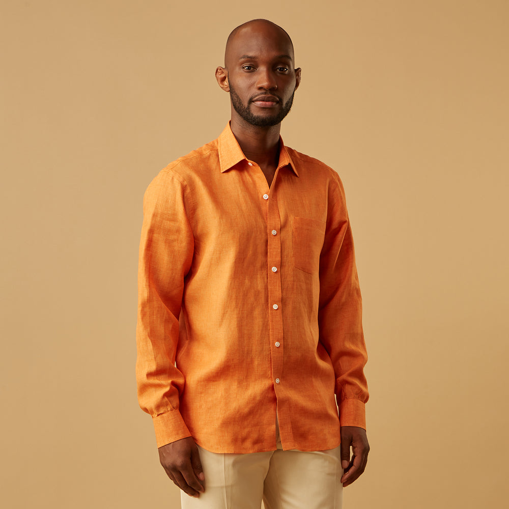 The Turnbull & Asser Orange Weekend Fit Linen Nevis Shirt features a Derby collar, long sleeves with 1-button cuffs, white buttons, and a chest pocket, shown flat against a white background.