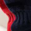 View 5 of product A man stands in the Turnbull & Asser Navy Lewis Guernsey Knitted Jumper.