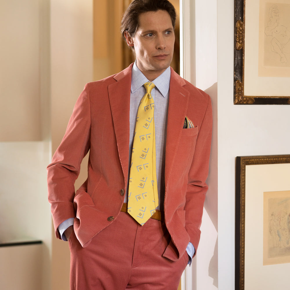 The Turnbull & Asser Pink Cord Bern Blazer features notch lapels, two brown buttons, three front pockets, and buttoned cuffs, showcasing Italian tailoring against a plain white background.