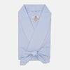 View 1 of product The Turnbull & Asser Blue & Pink Poplin Cotton Check Dressing Gown features a wide collar, pink trim, and a front sash—stylish and compact enough to pack for your next trip.