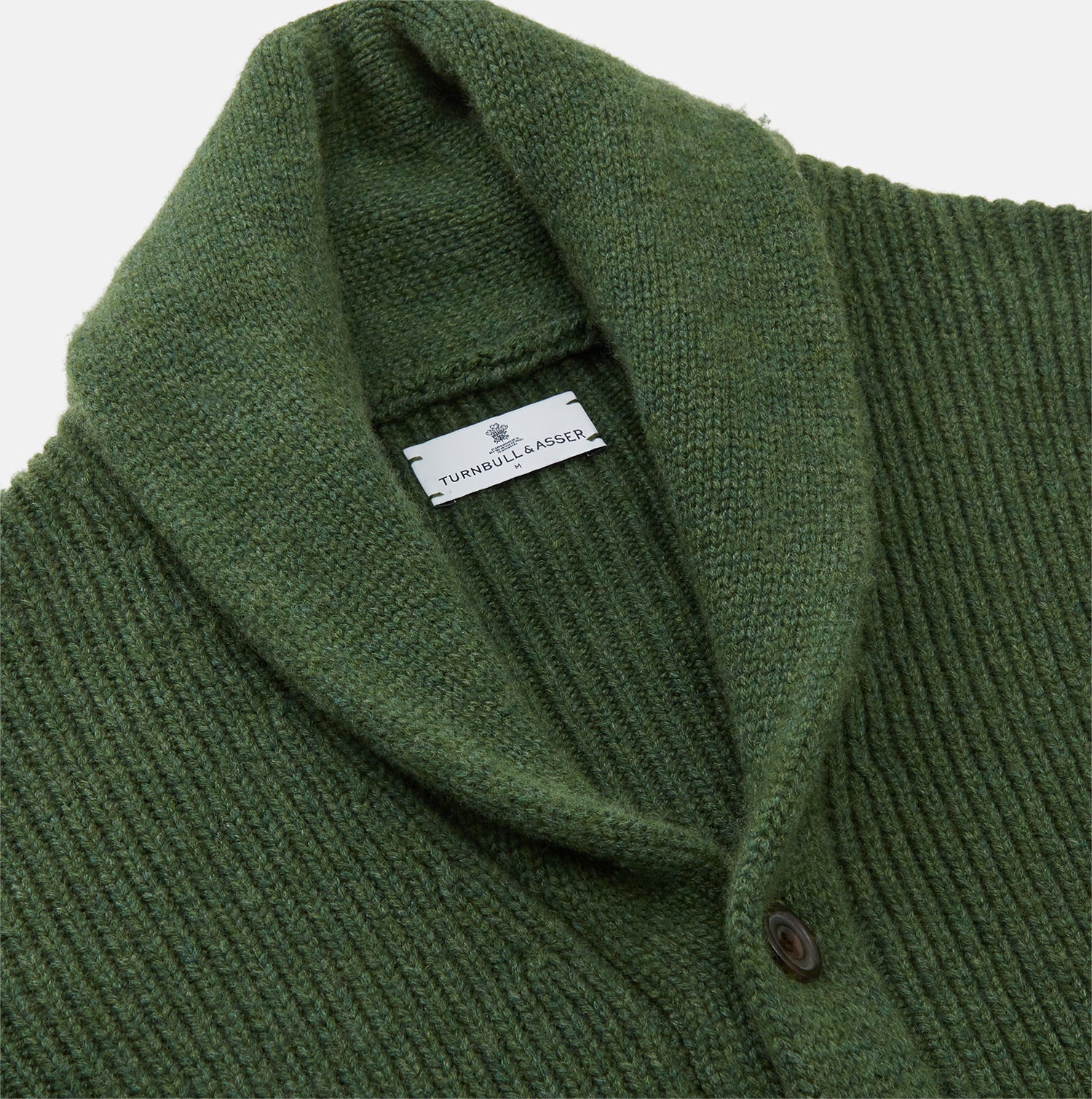 View 2 of product The Turnbull & Asser Serpentine Green Ribbed Cashmere Ainsley Cardigan features a button-up front, two pockets, and a shawl collar, shown laid flat on a white background.