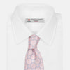 View 4 of product The Turnbull & Asser Baby Pink and Blue Circle Jacquard Silk Tie features a subtle geometric pattern, elegantly rolled against a plain white background.