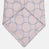View 3 of product The Turnbull & Asser Baby Pink and Blue Circle Jacquard Silk Tie features a subtle geometric pattern, elegantly rolled against a plain white background.