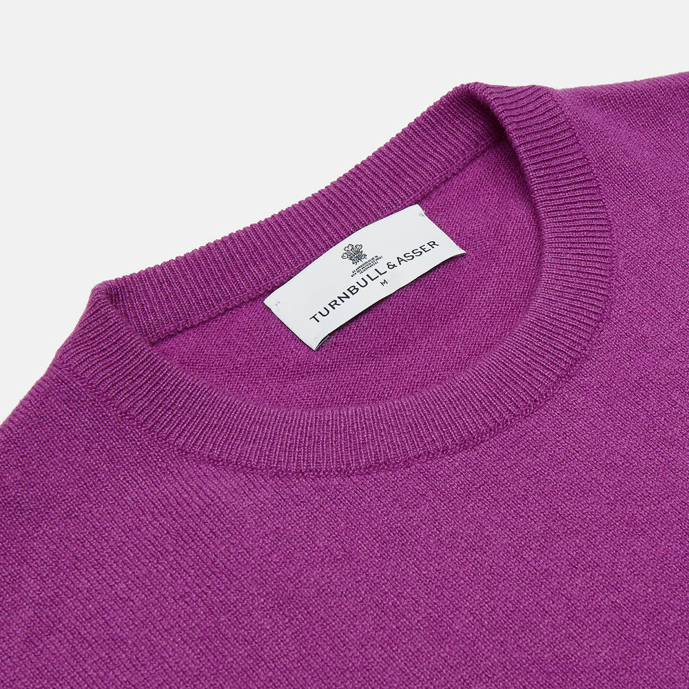 The Turnbull & Asser Magenta Cashmere Crewneck Jumper, featuring ribbed cuffs, hem, and collar, is shown against a plain white background.