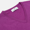 View 2 of product The Turnbull & Asser Magenta Cashmere V-Neck Jumper features long sleeves, ribbed cuffs, and a ribbed hem, shown against a plain white background.