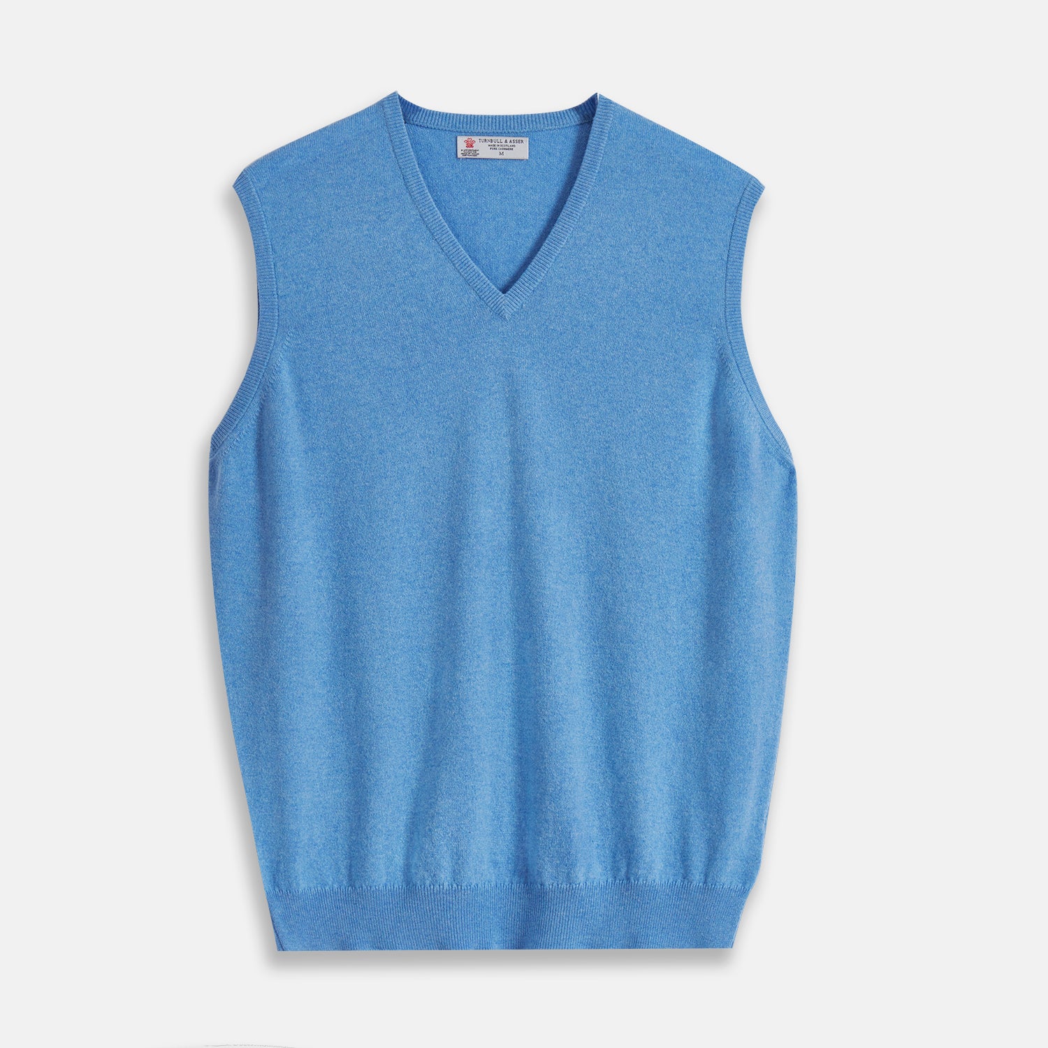View 1 of product The Sky Blue Fine Cashmere Slipover by Turnbull & Asser is laid flat on a white background, showcasing its lightweight design and ribbed neckline, armholes, and hem for a refined finish.