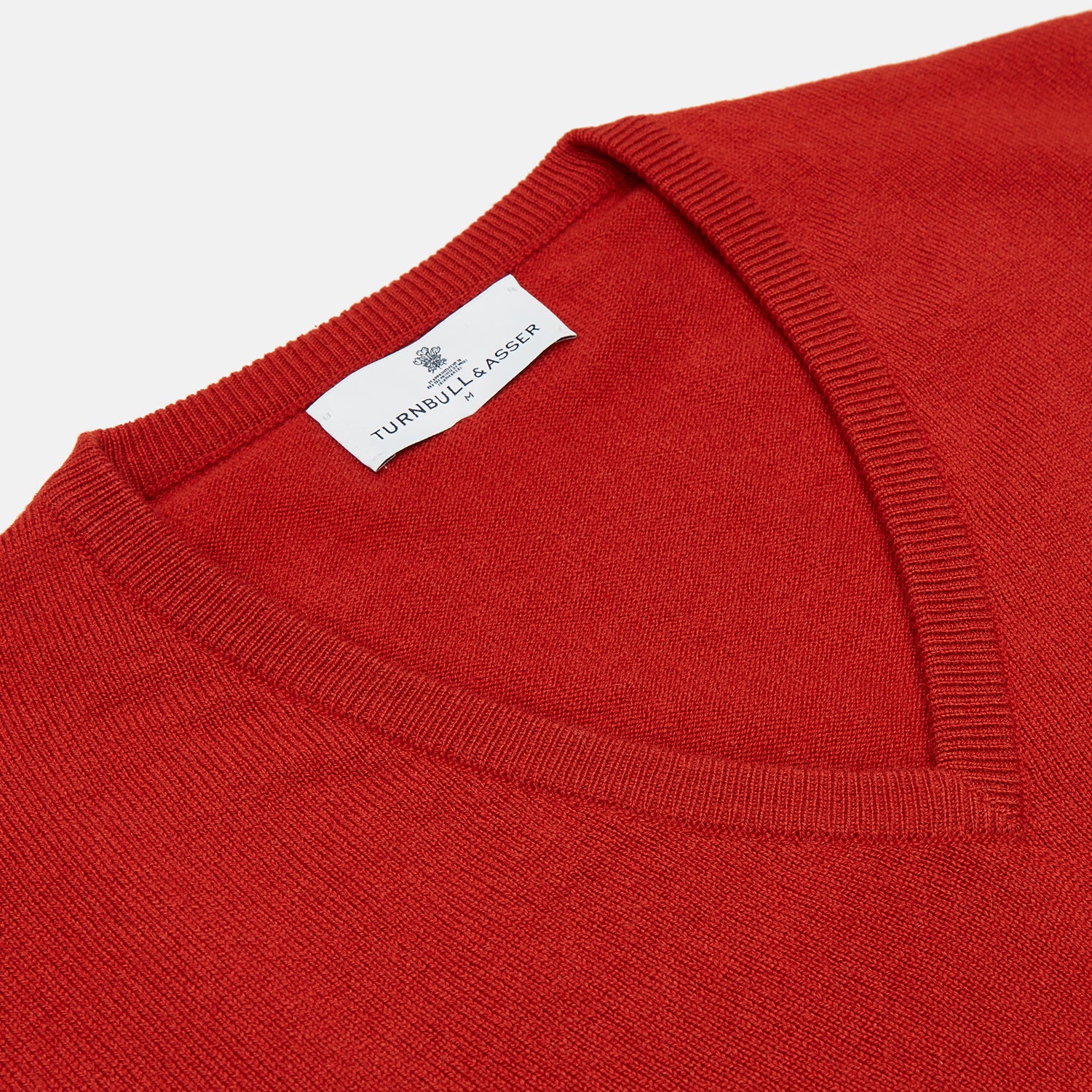 View 2 of product The Red Cashmere Slipover by Turnbull & Asser is a sleeveless, V-neck vest in pure cashmere, shown flat on a white background—an ideal lightweight layer for any season.