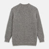 View 5 of product The Turnbull & Asser Merino Knitted Raglan Sleeve Crewneck Jumper in gray features intricate front and sleeve knit patterns, a high neckline, and long sleeves—an essential piece of men’s knitwear. Laid flat on a white background.