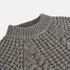 View 4 of product The Turnbull & Asser Merino Knitted Raglan Sleeve Crewneck Jumper in gray features intricate front and sleeve knit patterns, a high neckline, and long sleeves—an essential piece of men’s knitwear. Laid flat on a white background.