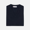 View 1 of product A neatly folded Turnbull & Asser Navy V-Neck Cashmere Slipover is displayed on a plain white background, its inner neckline label visible.