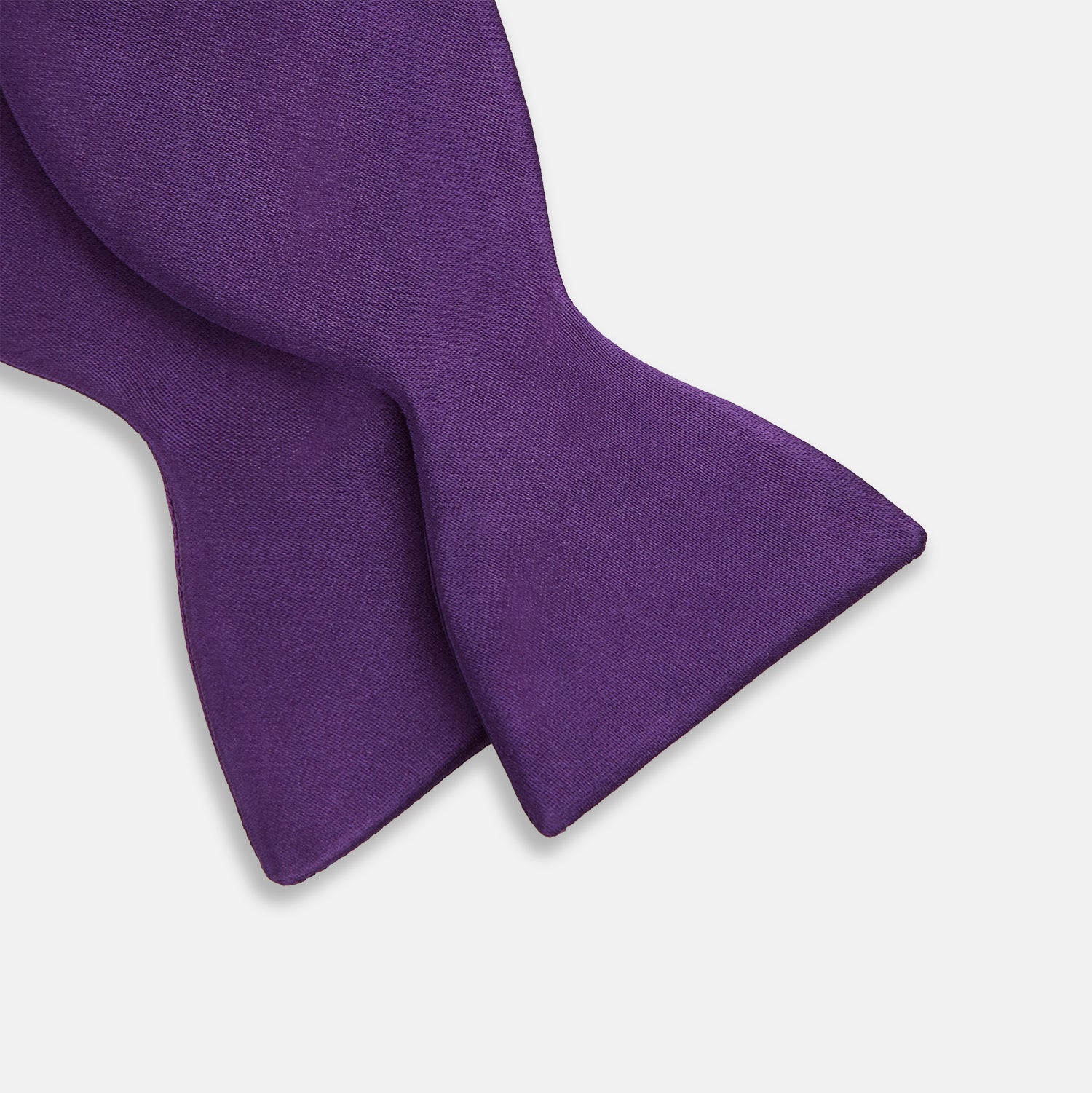 View 3 of product The Turnbull & Asser Plum Plain Satin Silk Bow Tie features a smooth texture and is neatly tied, displayed against a plain white background.