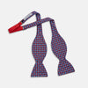 View 2 of product The Turnbull & Asser Burgundy and Blue Circle and Spot Silk Bow Tie showcases a formal patterned design of circles and spots on silk, presented on a plain white backdrop.