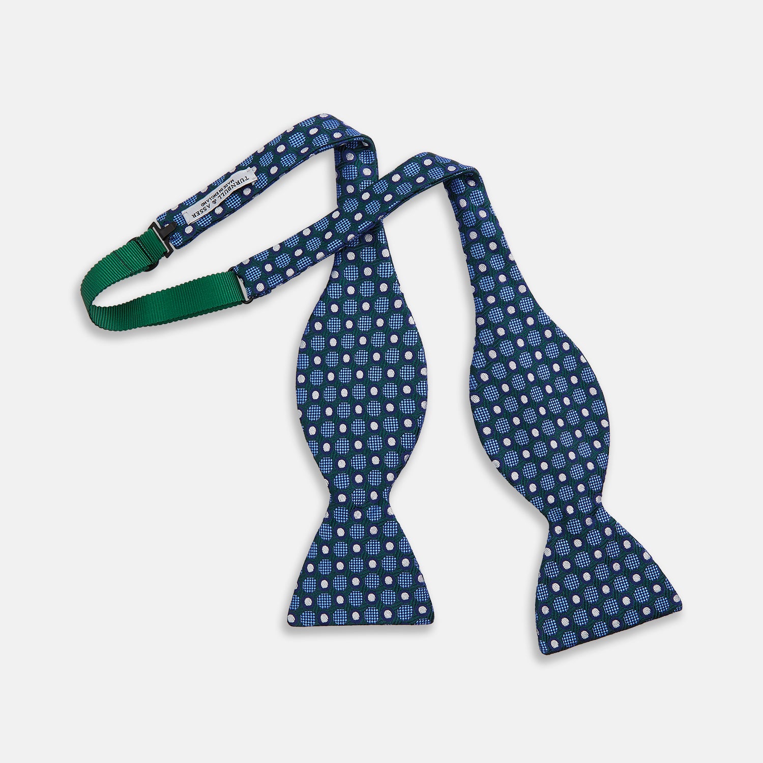View 2 of product The Turnbull & Asser Forest Green and Blue Circle and Spot Silk Bow Tie showcases a blue, green, and white dotted pattern, set against a plain white background.