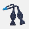 View 2 of product The Turnbull & Asser Navy and Blue Paint Spot Silk Bow Tie features a refined pattern of blue dots on navy, making it an essential addition to any men's accessories collection. Photographed on a plain white background.