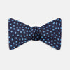 View 1 of product The Turnbull & Asser Navy and Blue Paint Spot Silk Bow Tie features a refined pattern of blue dots on navy, making it an essential addition to any men's accessories collection. Photographed on a plain white background.