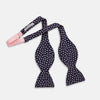 View 2 of product The Navy and Pink Paint Spot Silk Bow Tie by Turnbull & Asser features small, light pink oval dots evenly spaced on navy blue silk, creating a stylish formal accessory.