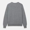 View 3 of product The Turnbull & Asser Flannel Grey V-Neck Cashmere Jumper, shown laid flat on a white background, features long sleeves and ribbed cuffs, hem, and neckline for a classic look with no visible patterns or embellishments.