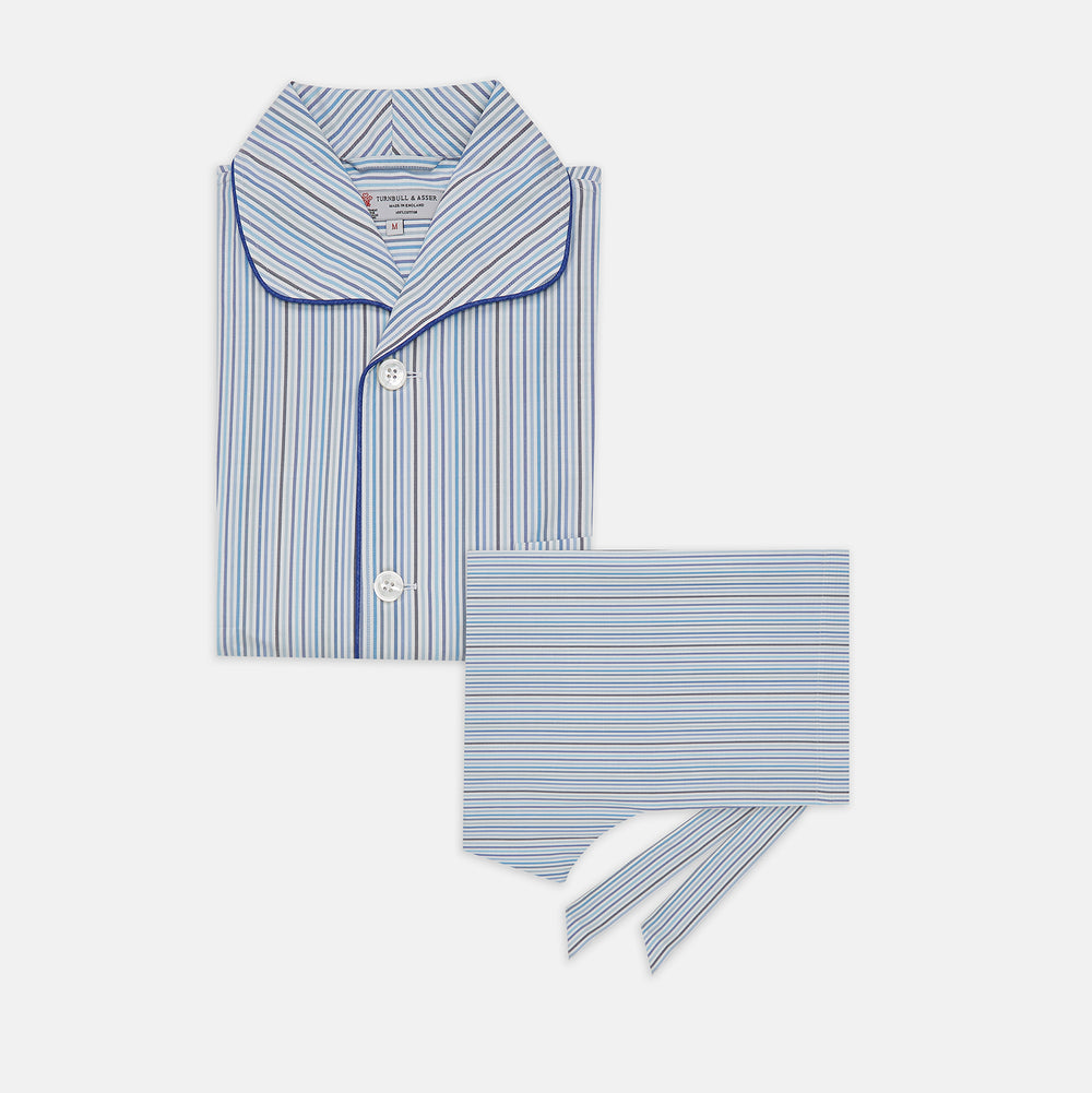 Turnbull & Asser’s Blue & White Twill Cotton Stripe Pyjama Set features a folded top with white buttons, dark blue piping, and a matching striped fabric belt, displayed on a white background.