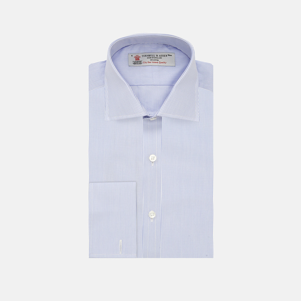 The Turnbull & Asser Blue and White Sea Island Quality Cotton Fine Bengal Stripe Shirt features a Regent collar, double cuffs, white buttons, and a front pocket. Displayed neatly folded against a plain white background.