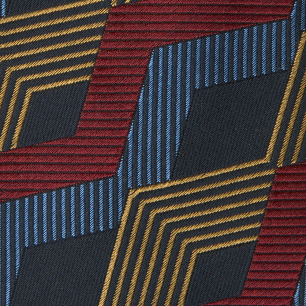 The Navy, Red and Gold Zig Zag Silk Tie by Turnbull & Asser features a geometric pattern of zigzag stripes on a dark background and is part of our limited-run collection.