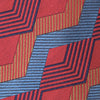 View 3 of product The Turnbull & Asser Red and Blue Zig Zag Silk Tie is a limited-run silk tie featuring interlocking geometric zigzag shapes and diagonal stripes in red, blue, gold, and navy.