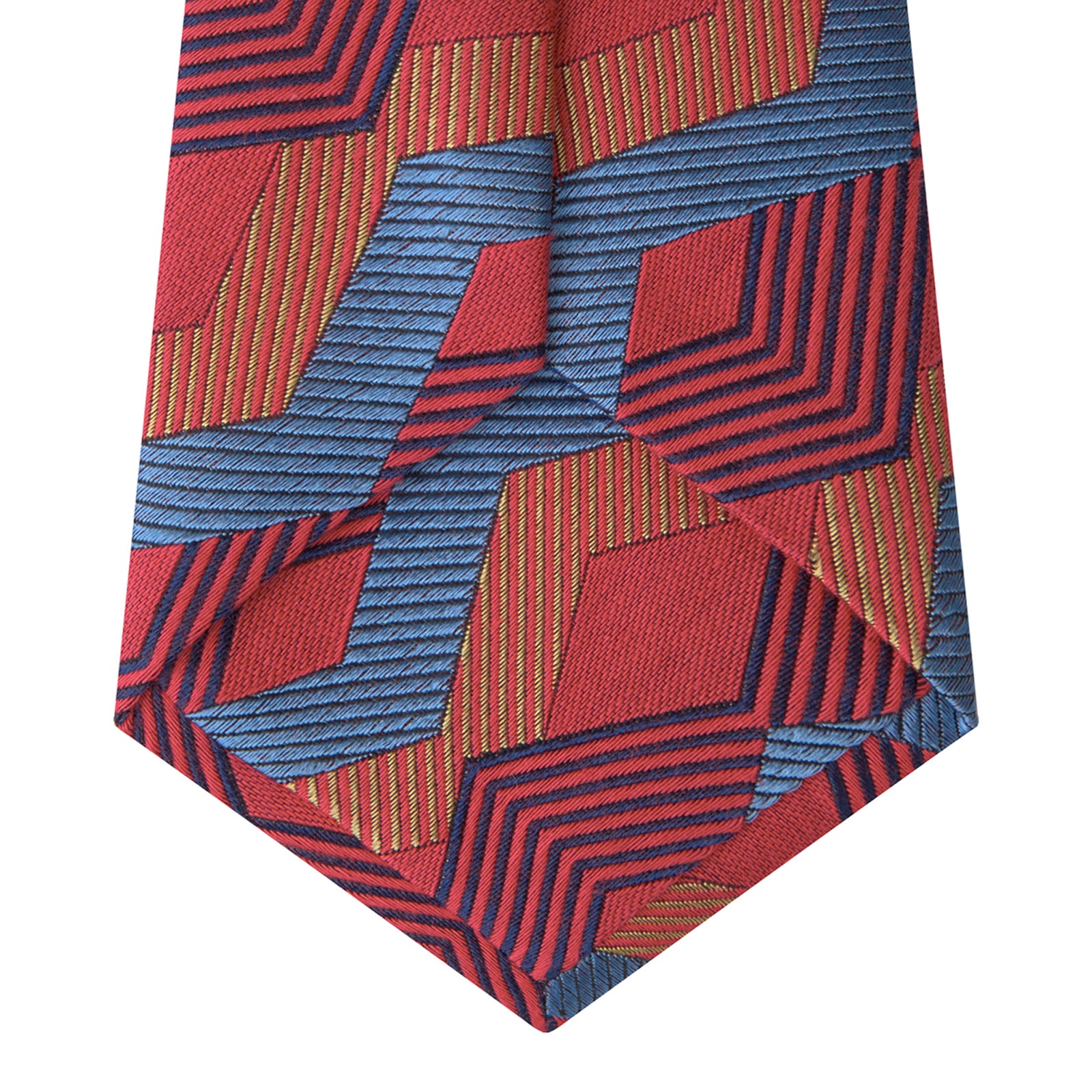 View 4 of product The Turnbull & Asser Red and Blue Zig Zag Silk Tie is a limited-run silk tie featuring interlocking geometric zigzag shapes and diagonal stripes in red, blue, gold, and navy.