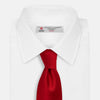 View 2 of product The Turnbull & Asser Red Horizontal Twill Silk Tie, rolled up, is ideal for adding a smart touch to cotton shirts.