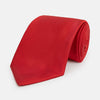 View 1 of product The Turnbull & Asser Red Horizontal Twill Silk Tie, rolled up, is ideal for adding a smart touch to cotton shirts.