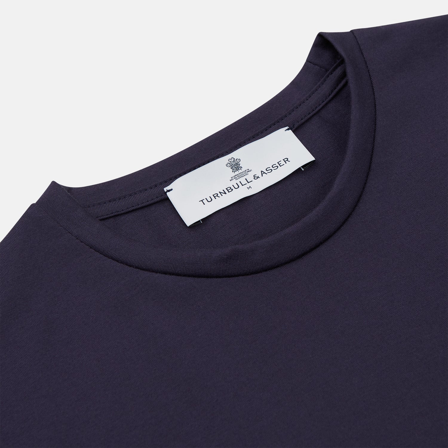 View 2 of product The Turnbull & Asser Navy Davey Cotton T-Shirt, made from fine-gauge jersey fabric, features short sleeves, a crew neck, and a small white tag with text inside the back collar, displayed flat on a white background.
