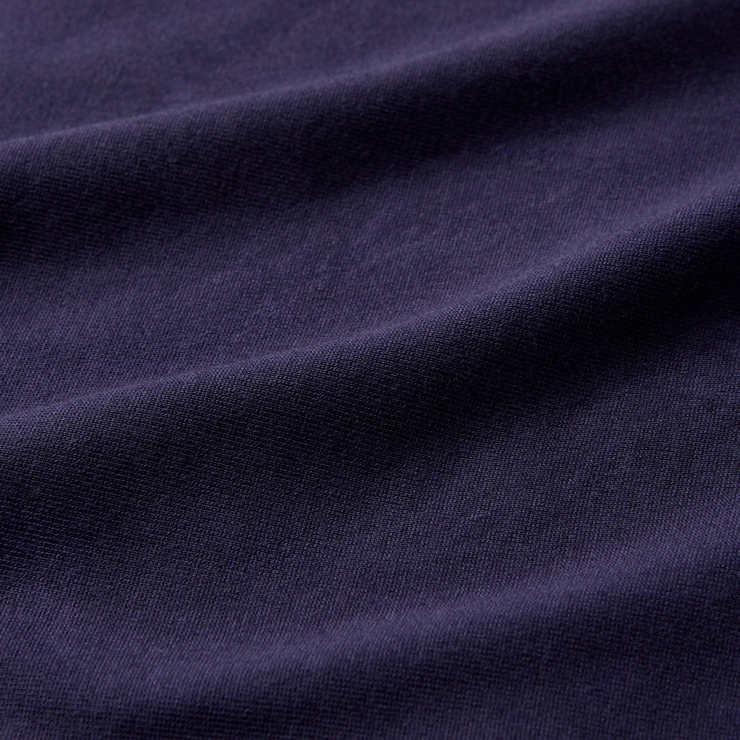 View 3 of product The Turnbull & Asser Navy Davey Cotton T-Shirt, made from fine-gauge jersey fabric, features short sleeves, a crew neck, and a small white tag with text inside the back collar, displayed flat on a white background.