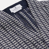 View 5 of product A barefoot person wears Turnbull & Asser's Navy Silk Chequered Kimono Gown with a belt over maroon pyjama sets, standing against a plain light background.