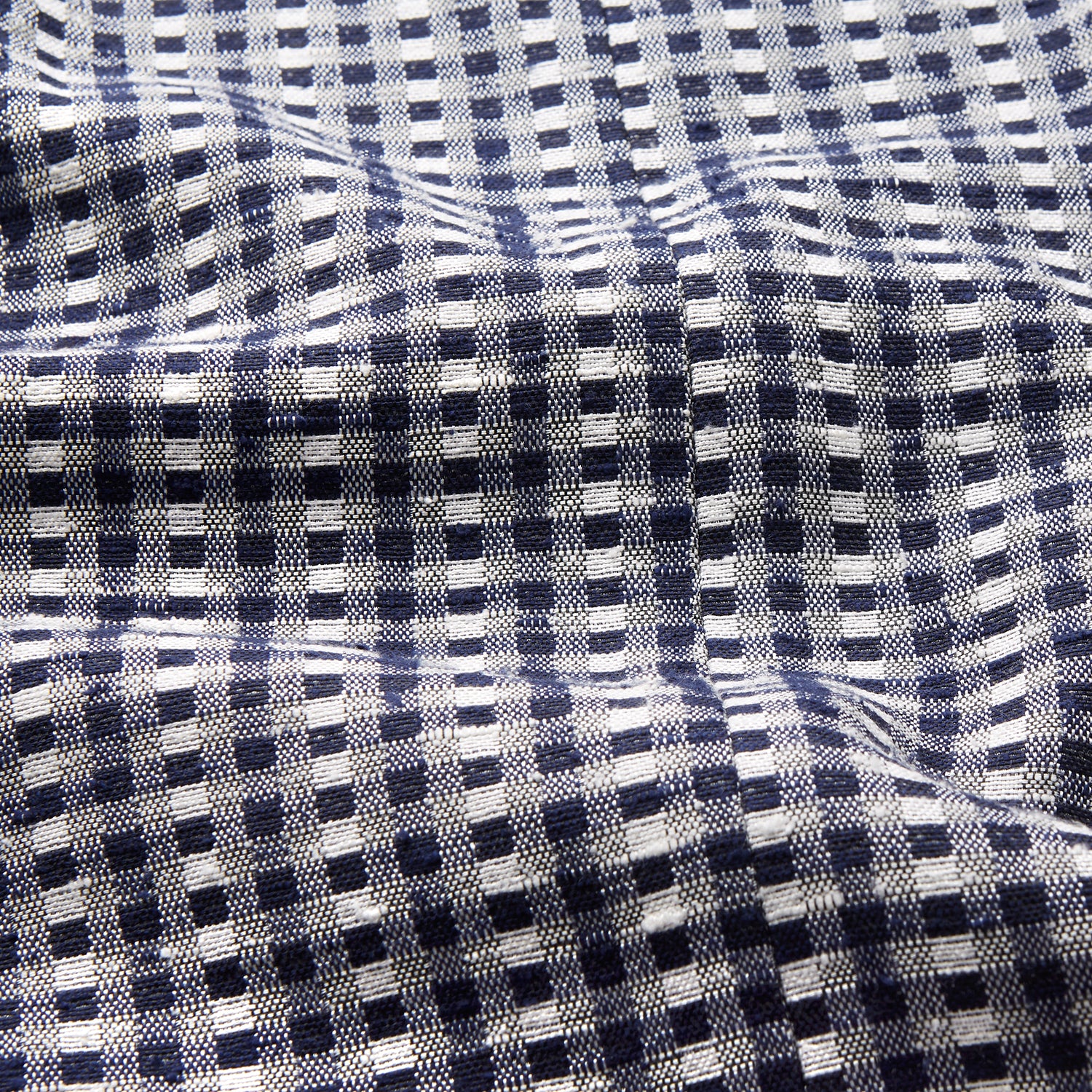 View 6 of product A barefoot person wears Turnbull & Asser's Navy Silk Chequered Kimono Gown with a belt over maroon pyjama sets, standing against a plain light background.