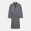 View 2 of product A barefoot person wears Turnbull & Asser's Navy Silk Chequered Kimono Gown with a belt over maroon pyjama sets, standing against a plain light background.