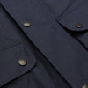 View 6 of product The Turnbull & Asser Navy Dry-Waxed Cotton Field Jacket features a collar, front zipper with snap buttons, two chest pockets, and large hip flap pockets, shown laid flat on a plain white background.