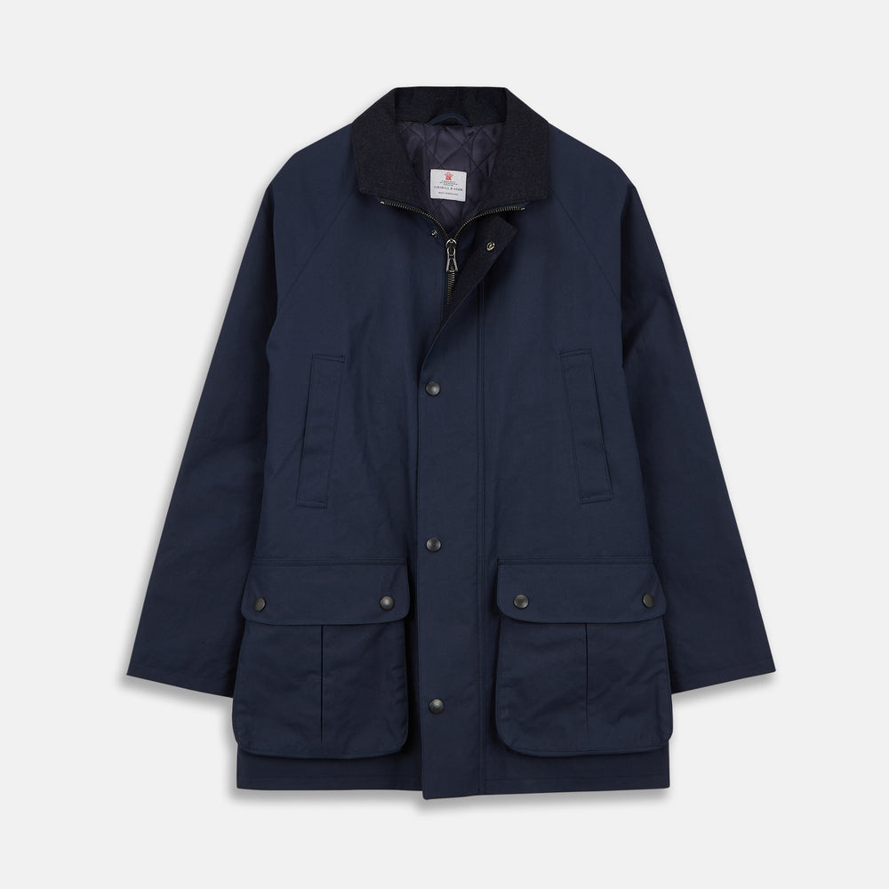 The Turnbull & Asser Navy Dry-Waxed Cotton Field Jacket features a collar, front zipper with snap buttons, two chest pockets, and large hip flap pockets, shown laid flat on a plain white background.